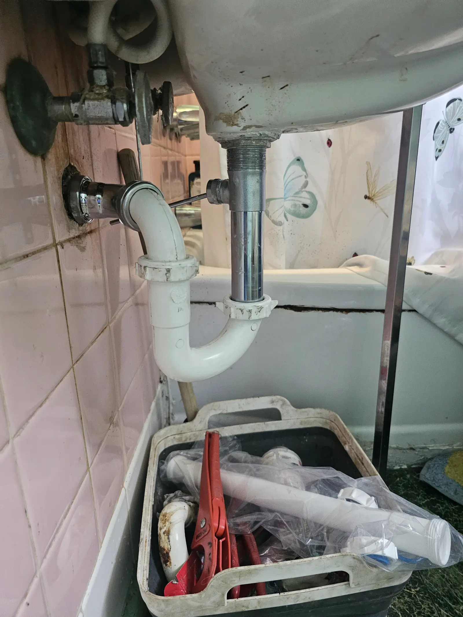 Bathroom sink drain being rebuilt with a new trap