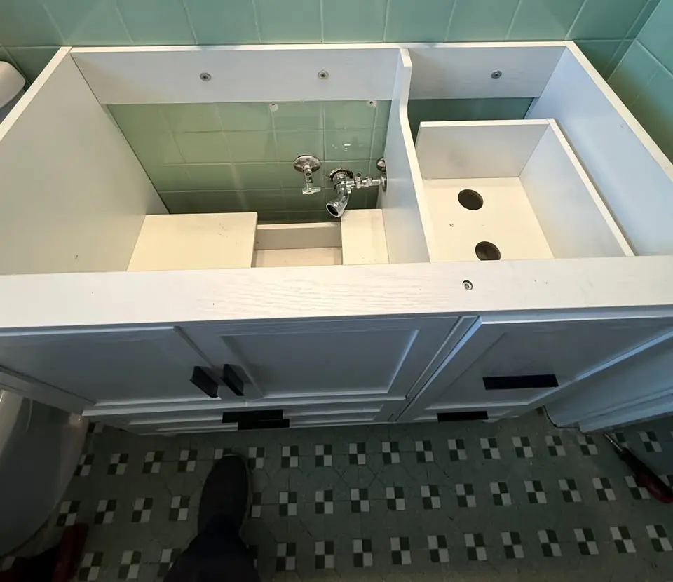 Double sink vanity being installed in a bathroom