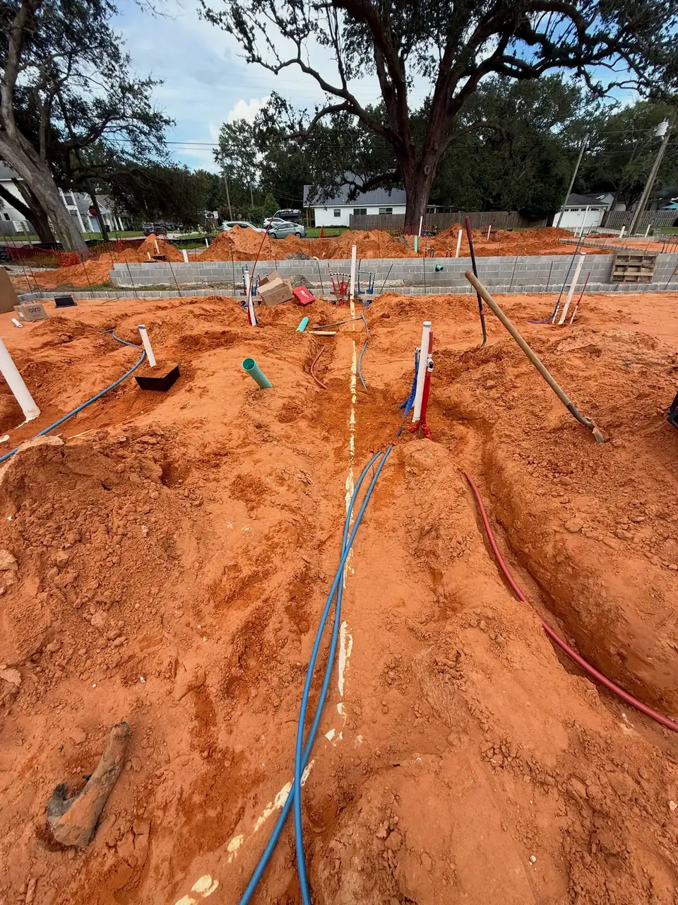 Underground PEX and PVC plumbing rough-in on a new home site