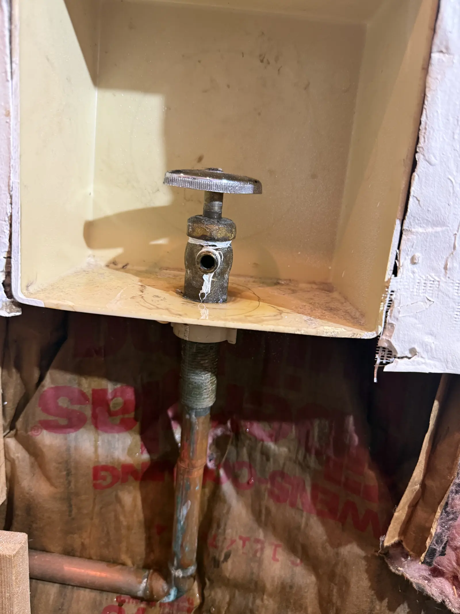Before: old multi-turn refrigerator water valve in a wall box